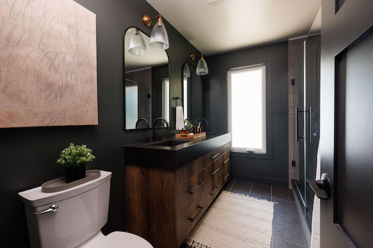 Dark bathroom with black paint and natural wood finishes