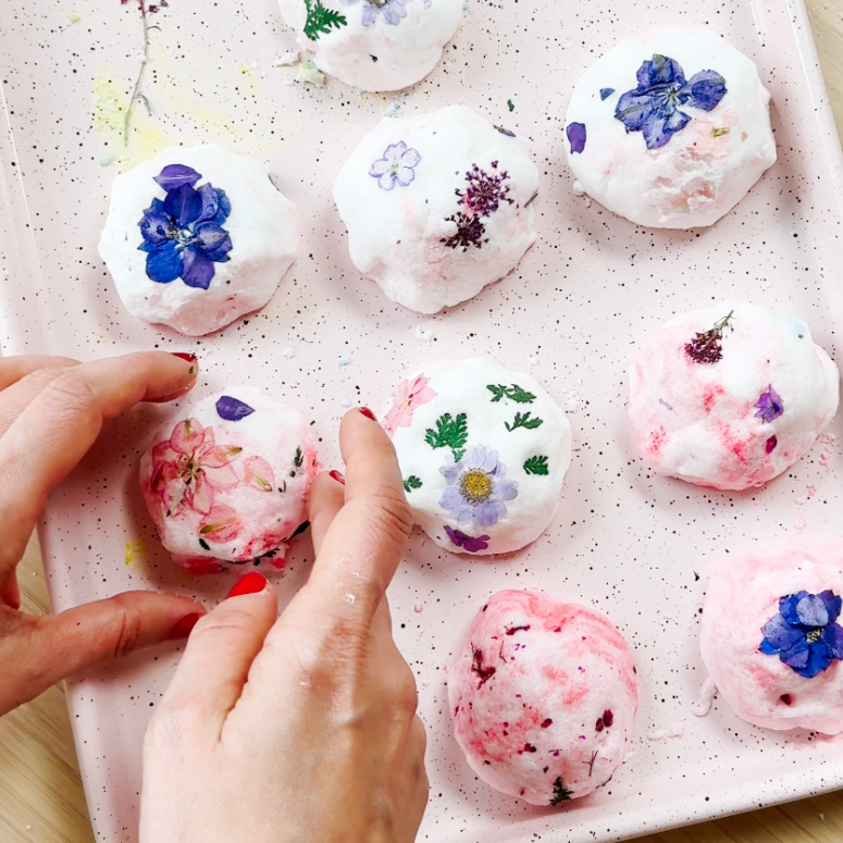 bath bombs on a pink tray made with dry flowers and food colouring for mother's day