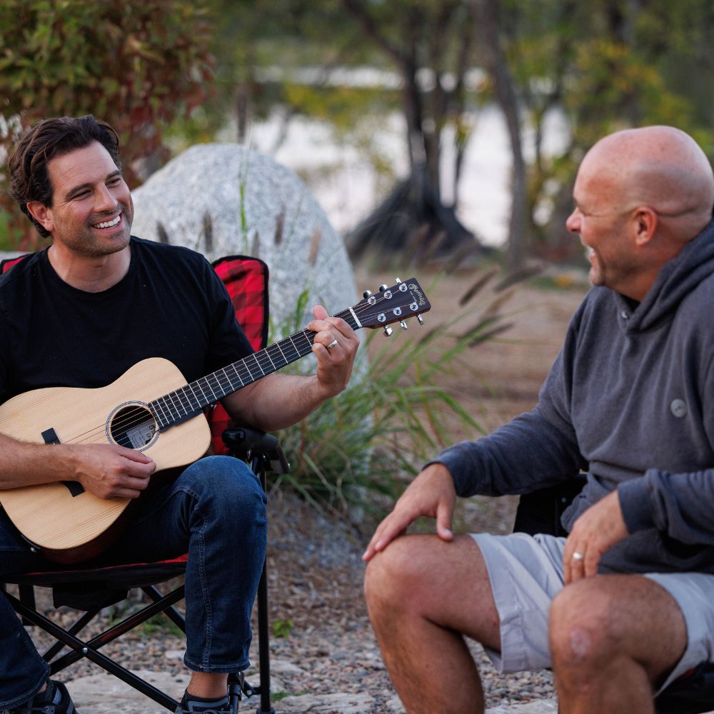Scott McGillivray and Bryan Baeumler by campfire