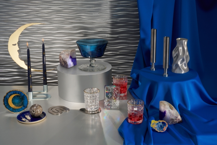 Display glassware, silver candle holders and vase, crystal and other celestial-inspired items.