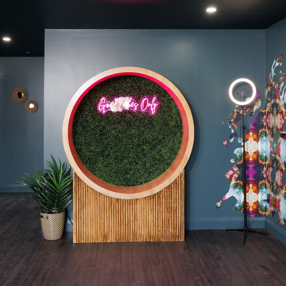 Rec room with deep blue wall and pink neon light