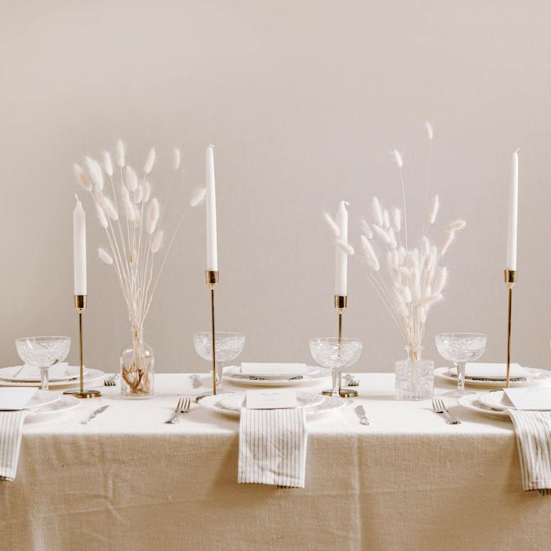 Table Setting over a Table Draped in White Table Cloth for a post about Tablescaping for HOME Network