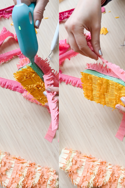 adding crepe paper to a mini piñata with a hot glue gun
