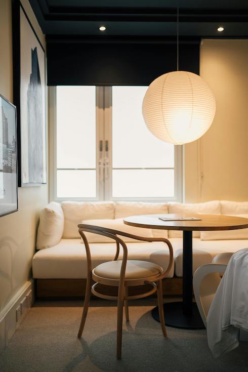 Cozy Minimalist Dining Nook with Soft Lighting for Home Network post on the Breakfast Nook trend