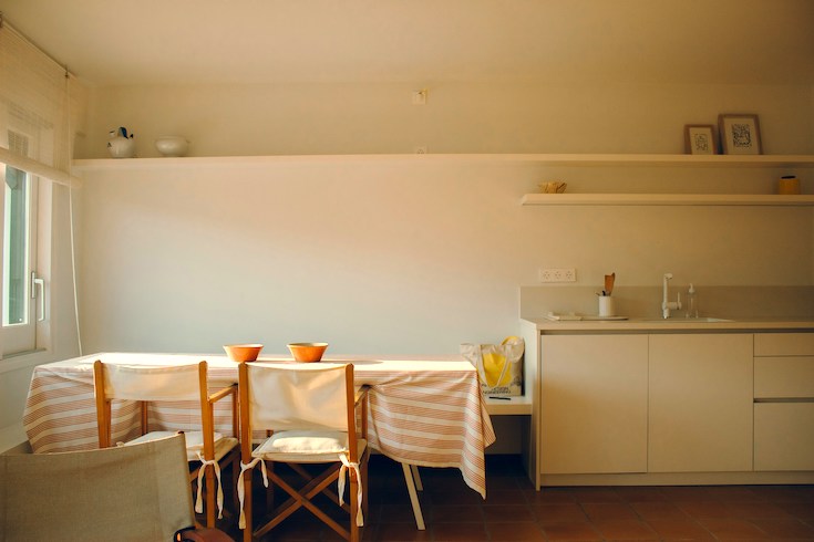 Simple white kitchen with built-in bench seat