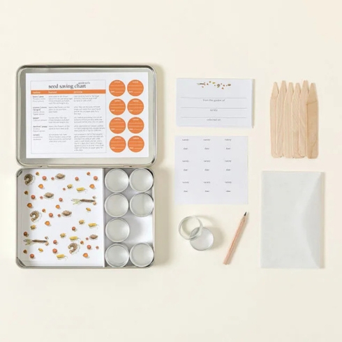 Seed Saving Kit Envelopes, seed tins and date/variety labels in a seed saving kit.