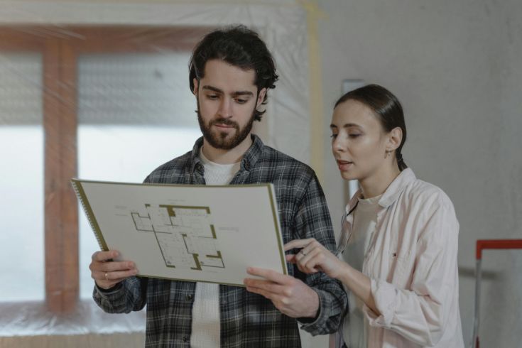 Two homeowners reviewing floor designs.