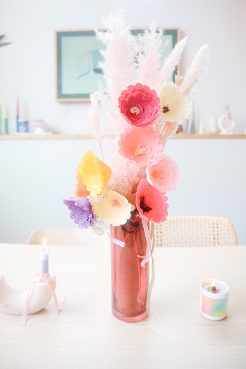 Bouquet of colourful paper flowers in a vase.