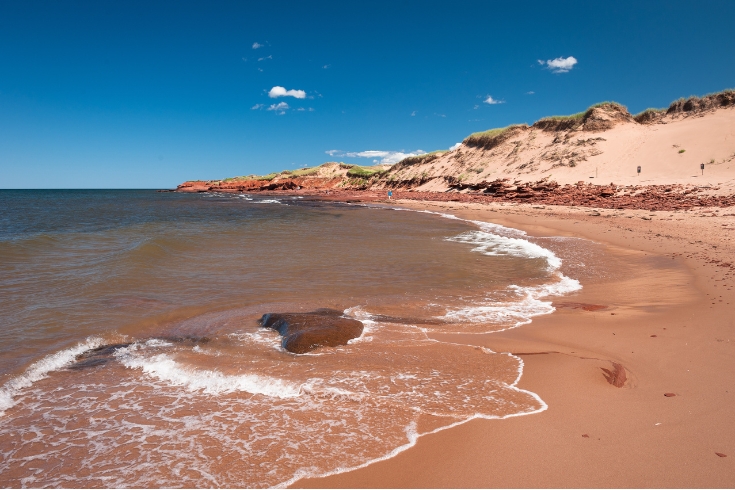 Beautiful summer day at the red sand cliffs at Cavendish Beach, Prince Edward Island National Park.