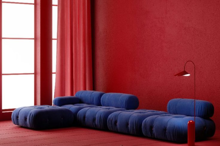 A cherry red room with a deep blue couch