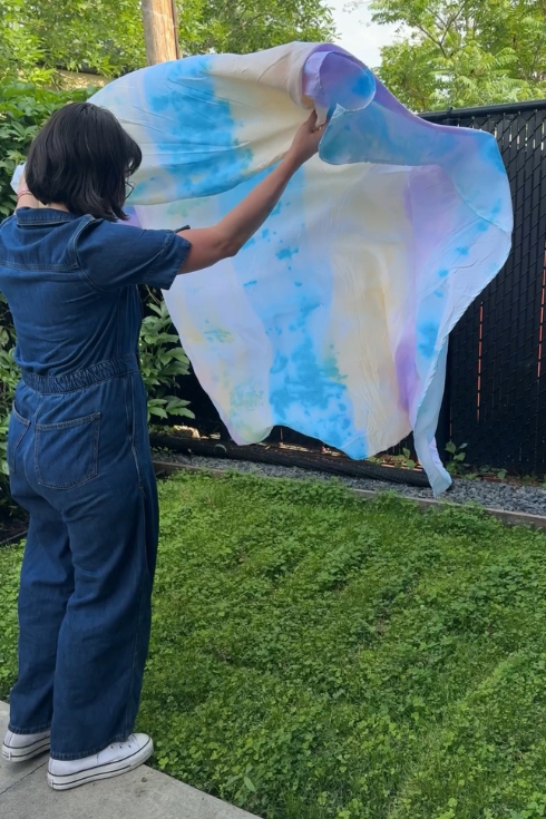 Displaying final product of tie-dye blanket.
