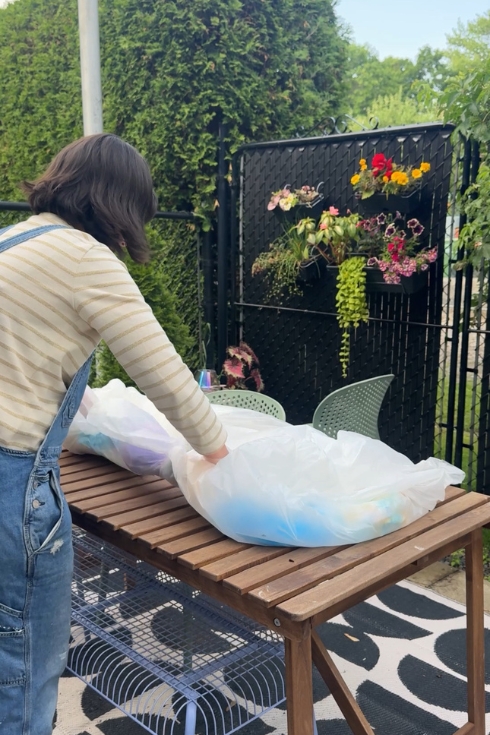 Wrapping dyed blanket in plastic.