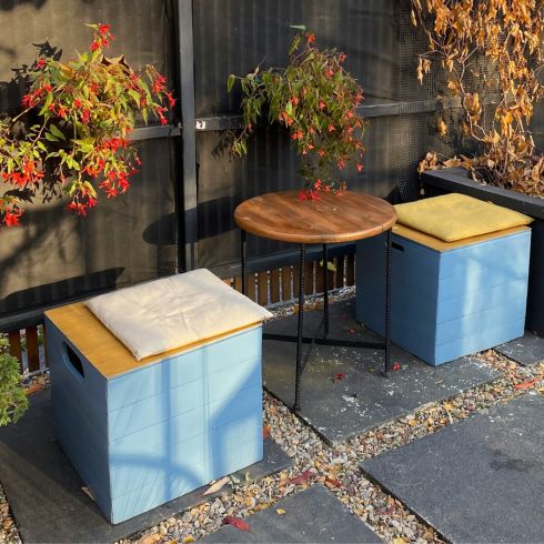 Blue and yellow square storage boxes that also serve as outdoor seating.