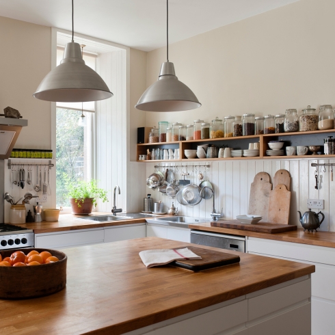 Display Cutting Boards Spacious kitchen with open shelving and solid oak work surfaces.