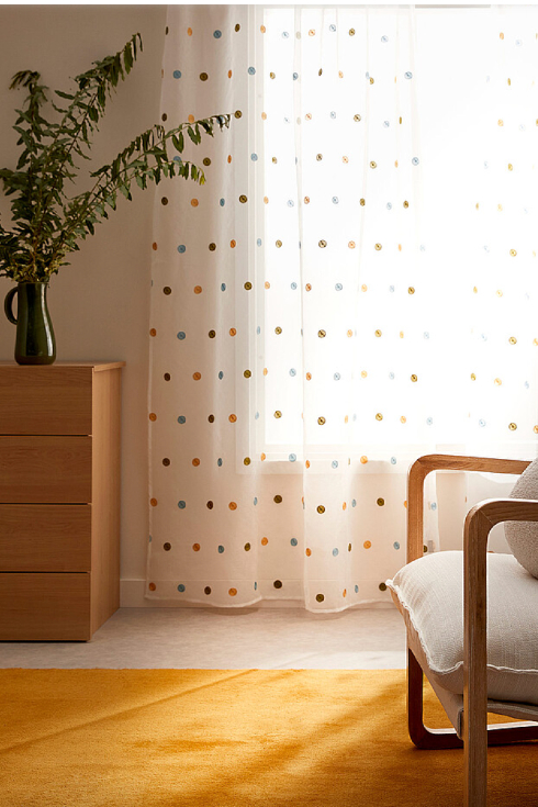 A polka dot curtain in a aesthetic living room