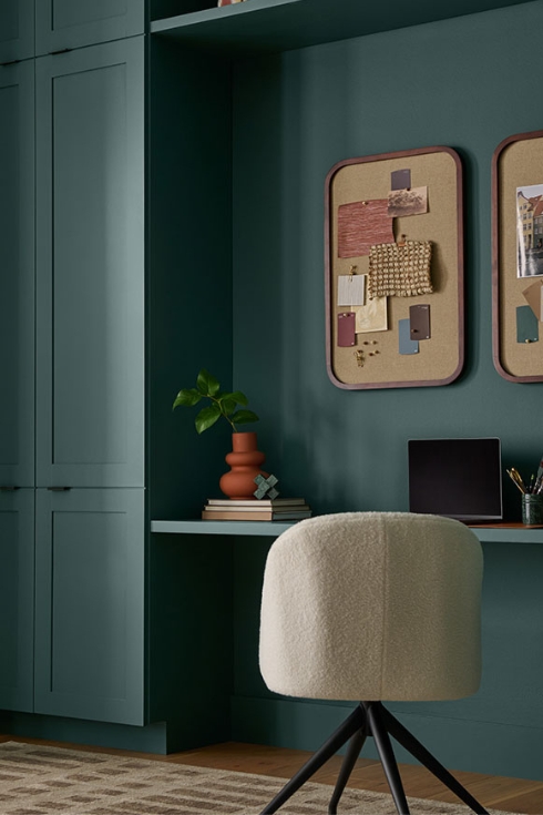Home office with desk and chair painted in Hidden Gem hue from Behr.