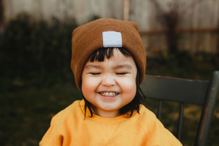 Two year old girl with the sweetest, biggest smile.