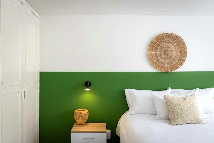 Wicker Plate over a bedroom against a green block colour wall