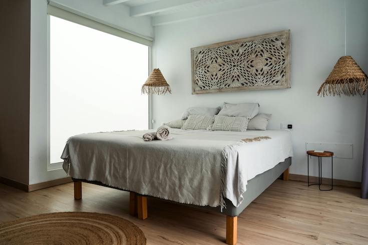 Modern Minimalist Bedroom with wooden wall decor above the bed